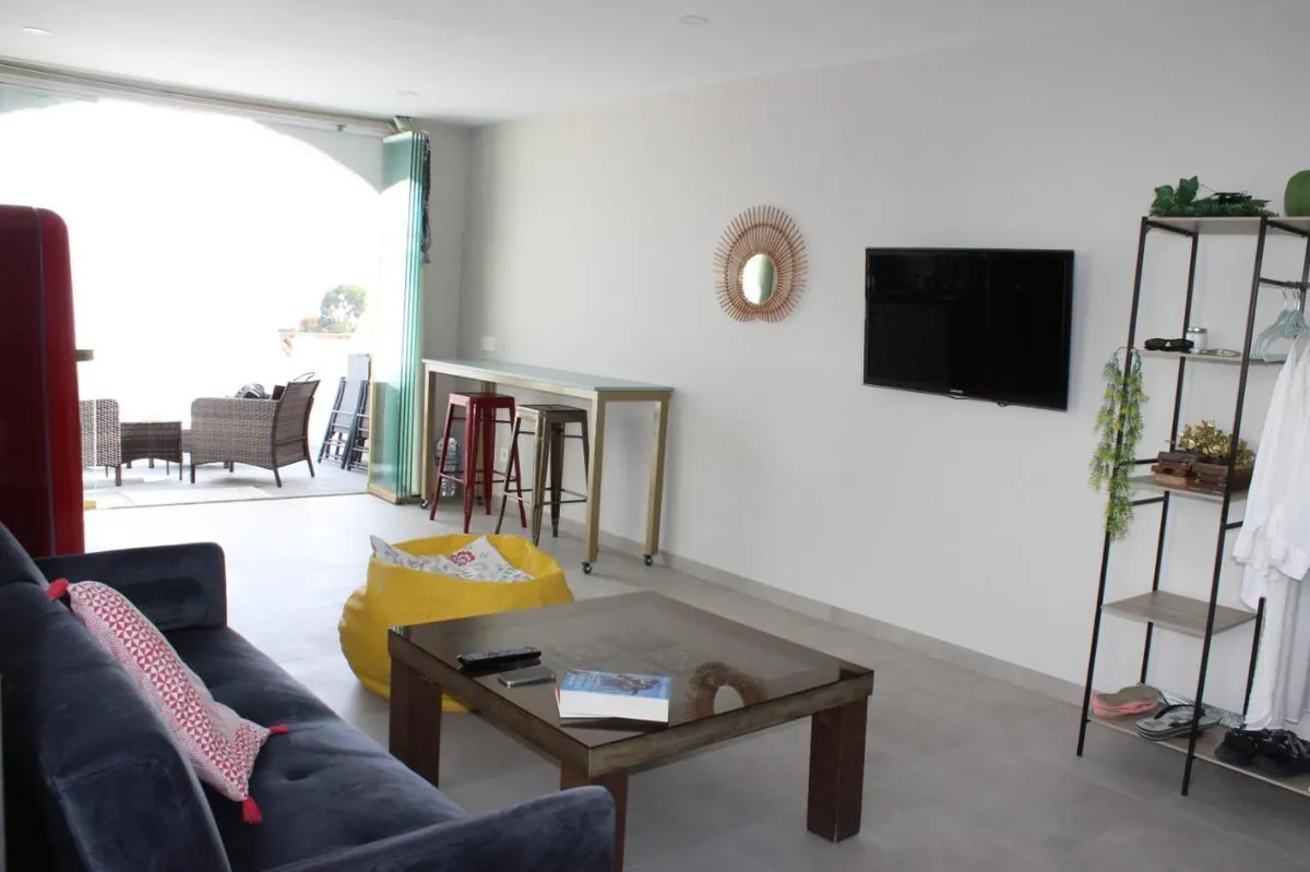 Living room with sofa opening onto the terrace